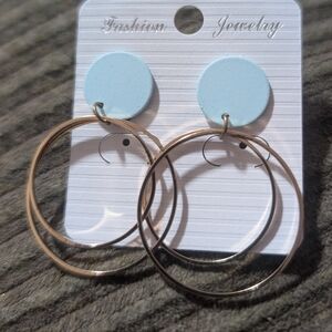 fashion earrings featuring a round, light blue stud connected to two overlapping